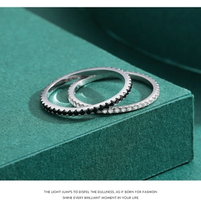 Macro detail of minimalist S925 silver rings with black and white pavé set gemstones