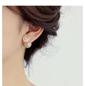 Close-up of a woman wearing gold zircon pearl front-back earrings in a French retro style
