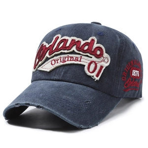 Vintage washed navy denim baseball cap with 3D letter embroidery and distressed details
