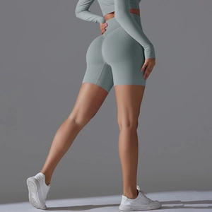 Side view of seamless high-waist yoga shorts and crop top set in slate blue knit fabric