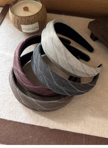 Detailed herringbone texture on padded headbands in grey, burgundy, and brown tones