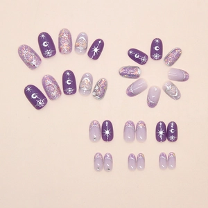 Detail of purple press-on nails featuring 3D heart motifs, stars, and glitter accents