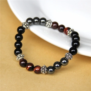 Detailed shot of tiger eye beads bracelet with silver spacers on a white plate
