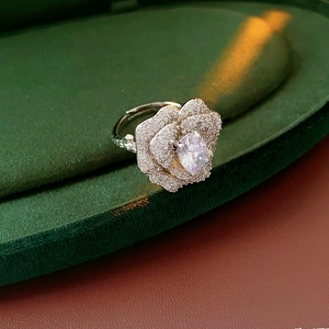 Detailed close-up of a zircon flower ring with an oval center stone and silver petals
