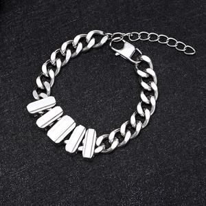 Men's silver Cuban link bracelet with rectangle metal charms on black textured background