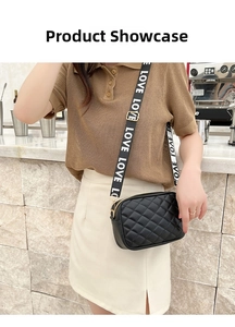 Detail shot of a black quilted crossbody bag with a wide LOVE letter strap on a model