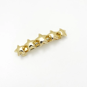 Close-up of golden alloy hair clip featuring five connected minimalist star shapes