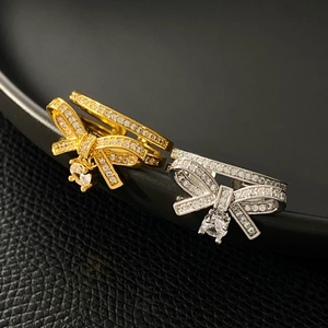Sparkling copper bow ring with zircon stones in gold and silver finish, open band style