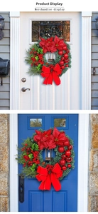 Christmas wreath with red poinsettia flowers berries and vintage black lantern detail
