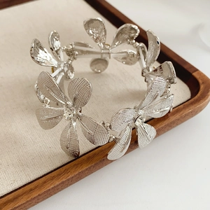 Detailansicht eines silbernen Blumenarmbands mit Kristallen auf einem Schmucktablett