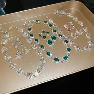 Detailed view of vintage crystal water drop necklace and earring set in three colors
