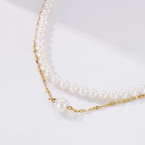 Detail of double-layer necklace with white faux pearls and golden titanium steel chain