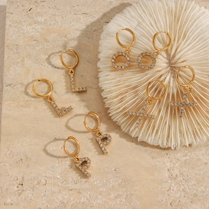 Detail of 18K gold plated hoop earrings with micro-inlaid cubic zirconia pendants