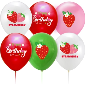 Detail view of strawberry themed birthday balloons in red, white and green colors