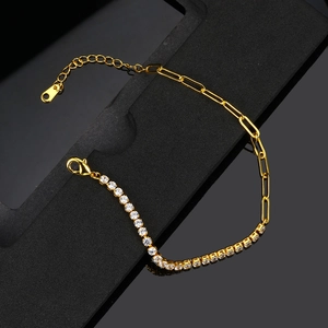 Gold tennis and paperclip link chain bracelet with clear zircon on black background