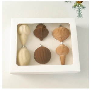 Set of 6 flocked Christmas ornaments in neutral tones inside a white window box packaging