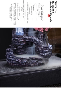 Detail of mountain landscape backflow incense burner with realistic mist effect and pink tree