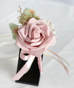 Close-up of pink PE rose boutonniere with golden berries and silk ribbon detail