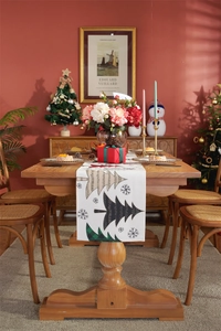 Detailed view of thick cotton-linen Christmas table runner with festive tree prints