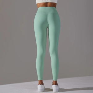 Detail view of high waist mint green yoga leggings with seamless butt lifting design