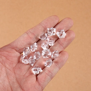 Transparent acrylic crushed ice cubes for photography props shown in hand for size