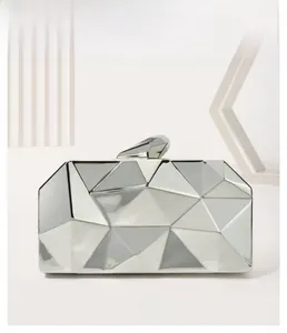 Detailed view of a silver geometric faceted evening clutch bag with metal clasp and hardware