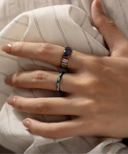 Close-up of S925 sterling silver rainbow rectangular gem ring and turquoise stone band
