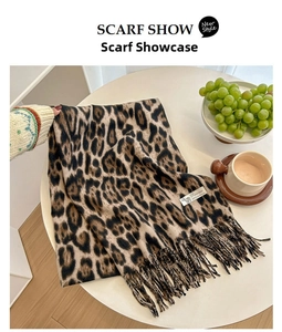 Detailed close-up of leopard print cashmere feel scarf with soft fringe edges and warm texture