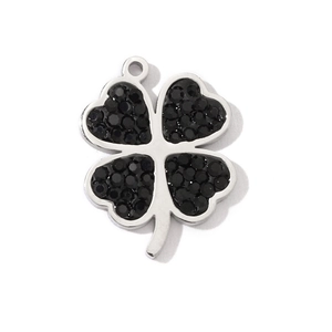 Detailed close-up of lucky four-leaf clover pendant with black stone in silver steel frame