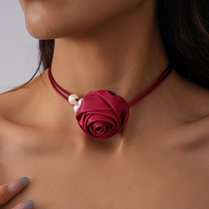 Detailed close-up of a burgundy fabric rose choker with delicate white pearls for women