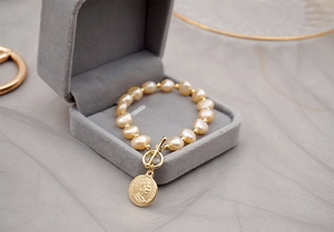 Detail of baroque freshwater pearl bracelet with 18K gold OT buckle and coin pendant
