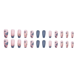 Blue and pink press-on nails with heart patterns, metal bows, and pearl accents