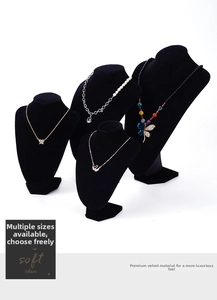 Lot de quatre bustes de collier en velours noir de différentes hauteurs sur fond blanc