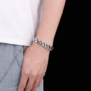 Macro shot of a men's stainless steel dragon scale link chain bracelet on a wrist