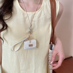 Close-up of a white mini croissant pouch necklace with gold clasp and beige rope chain