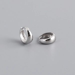 Detailed view of polished S925 sterling silver wide hoop earrings with a glossy finish