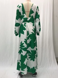 Detail of tropical leaf print long dress featuring a deep V-back and high waist cut