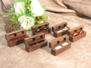 Detailed view of walnut ring box with magnetic closure and multi-color velvet linings
