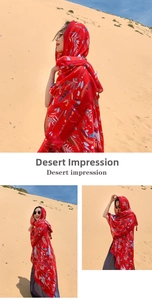 Close-up of red ethnic floral print shawl fabric with intricate desert style patterns