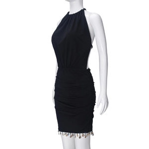 Detail view of the black halter dress featuring elegant ruching and beaded fringe hemline