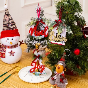 Detailed shot of Nordic Christmas wooden ornaments with glittery Joy and Noel lettering