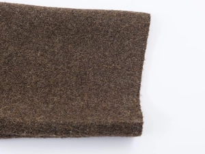 Detailed macro view of the thick brown felt fabric texture on this knitted winter scarf