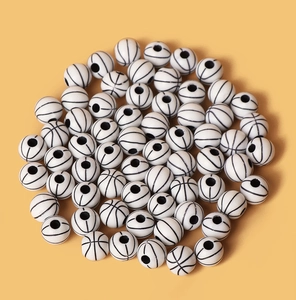 Macro shot of white acrylic basketball beads with black texture for jewelry making