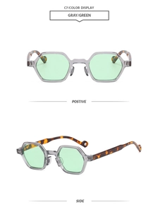 Detail of grey transparent hexagonal sunglasses with green lenses and tortoise temples