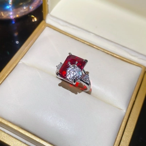 Macro detail of luxury red gemstone ring with crystal ladybug design in gift box