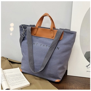 Detail view of large grey canvas tote bag with brown PU leather handles and Light Fashion print