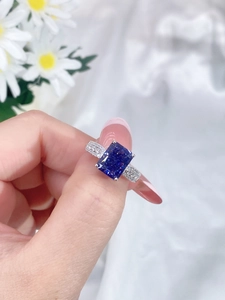 Macro shot of rectangular blue zircon gemstone ring with side stones on 925 silver band