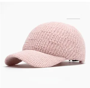 Top view of pink knitted baseball cap showing textured thick yarn and curved brim