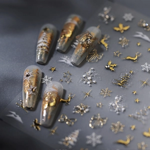 3D Christmas nail stickers with gold and white reindeer, trees, and snowflakes patterns
