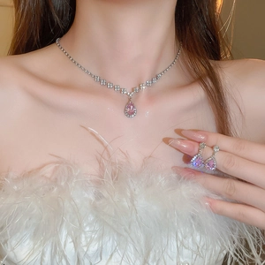Detail shot of vintage jewelry set featuring pink teardrop gems and sparkling crystals